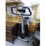 A REEBOK EXERCISE BIKE WITH DIGITAL SETTINGS