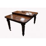 A VICTORIAN MAHOGANY WIND-OUT EXTENDING DINING TABLE WITH TWO ADDITIONAL LEAVES , the rounded oblong