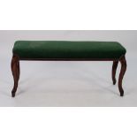 LATE NINETEENTH CENTURY CARVED WALNUT DUET STOOL, the close studded oblong padded seat covered in