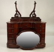 LATE VICTORIAN MAHOGANY INVERTED BREAKFRONT DRESSING CHEST, the shaped oval mirror in a moulded