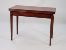NINETEENTH CENTURY MAHOGANY FOLD-OVER TEA TABLE, the moulded oblong top above a plain frieze, an