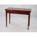 NINETEENTH CENTURY MAHOGANY FOLD-OVER TEA TABLE, the moulded oblong top above a plain frieze, an