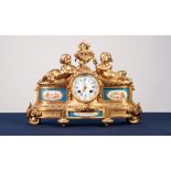 A LATE NINETEENTH CENTURY FRENCH GILDED SPELTER CASED SEVRES STYLE PORCELAIN INSET MANTEL CLOCK, the