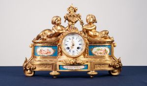 A LATE NINETEENTH CENTURY FRENCH GILDED SPELTER CASED SEVRES STYLE PORCELAIN INSET MANTEL CLOCK, the