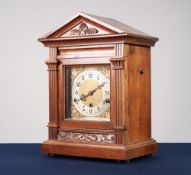 TWENTIETH CENTURY CARVED WALNUT MANTLE CLOCK, the 6 ½" brass dial with silvered Arabic chapter ring,