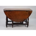 ANTIQUE OAK AND ELM DROP LEAF GATE LEG TABLE, the oval top above an end drawer fitted with brass