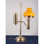 AN ADAPTED OIL LAMP WITH ORANGE GLASS GLOBE AND CLEAR GLASS FUNNEL