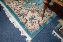 GOOD WASHED CHINESE EMBOSSED CARPET of Aubusson design on an emerald green field, having mushroom