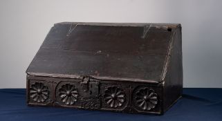 SEVENTEENTH CENTURY CARVED OAK BIBLE BOX, the front with hinged slope above four flowerhead carvings