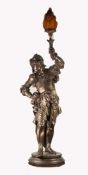 LARGE PATINATED SPELTER FIGURAL TABLE LAMP, modelled as a soldier, part clad in armour and holding a