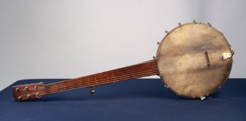 LATE NINETEENTH CENTURY 'STAR TRADE MARK' BANJO, with seven strings, 31 1/2" long, the black fibre