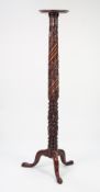 NINETEENTH CENTURY CARVED MAHOGANY TORCHERE, the moulded circular top above a spira fluted column