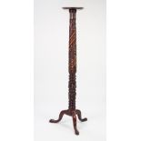 NINETEENTH CENTURY CARVED MAHOGANY TORCHERE, the moulded circular top above a spira fluted column