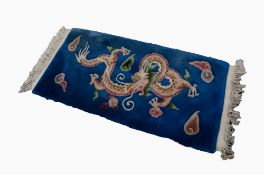 HEAVY QUALITY EMBOSSED WASHED CHINESE RUG, with large dragon design and sea creatures on a deep blue