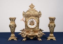 LATE NINETEENTH/ EARLY TWENTIETH CENTURY EMBOSSED BRASS MANTLE CLOCK, the 3 ½" Arabic dial with