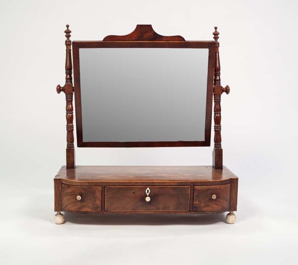 A GEORGE IV MAHOGANY TOILET MIRROR, crossbanded and strung with boxwood, fitted with three small