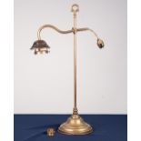 EARLY TWENTIETH CENTURY ADJUSTABLE BRASS DESK LAMP, with carrying handle, scroll arm and weighted