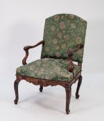 NINETEENTH CENTURY CONTINENTAL CARVED WALNUT FAUTEUIL, the arched back above moulded, wavy arms with