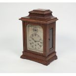 A CIRCA 1900 OAK CASED MANTEL CLOCK, the Gustav Becker three train chiming movement with a