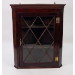 ANTIQUE FLAT FRONTED GLAZED MAHOGANY CORNER CUPBOARD, with exposed brass butterfly hinges, fancy