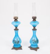 PAIR OF EARLY TWENTIETH CENTURY BLUE OPAQUE GLASS OIL TABLE LAMPS, each of baluster form with