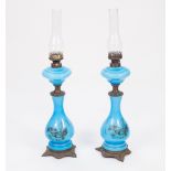 PAIR OF EARLY TWENTIETH CENTURY BLUE OPAQUE GLASS OIL TABLE LAMPS, each of baluster form with