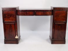WILLIAM IV FLAME CUT AND CARVED MAHOGANY TWIN PEDESTAL SIDEBOARD, the bow fronted, sunk centre