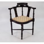 A VICTORIAN CORNER CHAIR, HAVING SHAPED TOP RAIL OVER PIERCED BACK SPLATS, PAD SEAT WITH STRIPED