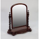 VICTORIAN FIGURED MAHOGANY LARGE TOILET MIRROR, the milestone plate housed in a moulded crossgrained