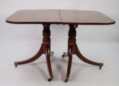 LATE GEORGIAN TWIN PILLAR MAHOGANY DINING TABLE WITH EXTRA LEAF, the rounded oblong top above a pair