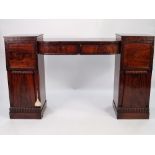 WILLIAM IV FLAME CUT AND CARVED MAHOGANY TWIN PEDESTAL SIDEBOARD, the bow fronted, sunk centre