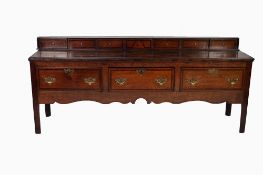 EIGHTEENTH CENTURY OAK AND MAHOGANY CROSSBANDED DRESSER, the oblong three plank top surmounted by