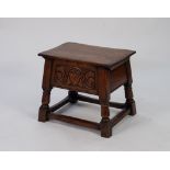 MODERN REPRODUCTION CARVED MEDIUM OAK BOX STOOL, the hinged oblong top above a deep front panel