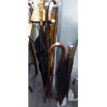 TWO WALKING STICKS WITH SILVER HEAD AND MOUNT, TWO OTHERS AND FOUR VINTAGE UMBRELLAS (8)