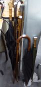 TWO WALKING STICKS WITH SILVER HEAD AND MOUNT, TWO OTHERS AND FOUR VINTAGE UMBRELLAS (8)