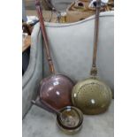 TWO BRASS AND COPPER BED WARMING PANS, AND A SET OF THREE GRADUATED BRASS PANS (5)