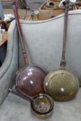TWO BRASS AND COPPER BED WARMING PANS, AND A SET OF THREE GRADUATED BRASS PANS (5)