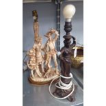 AN IVORINE FIGURAL GROUP TABLE LAMP AND A MODERN BRONZED METAL FIGURAL TABLE LAMP