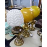 NEAR PAIR OF VICTORIAN BRASS OIL LAMPS, EACH WITH YELLOW GLOBE SHADES, ONE WITH GLASS FUNNEL, THE