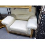 A CREAM HIDE HIDE LOUNGE SUITE, VIZ A THREE SEATER SETTEE AND A LOUNGE SUITE ON A PALE BEECH WOOD