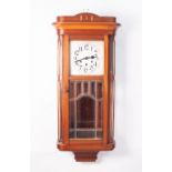 A WELLINGTON WALL CLOCK, WITH 8 DAYS STRIKING AND CHIMING MOVEMENT, WITH SILVERED ARABIC DIAL, IN