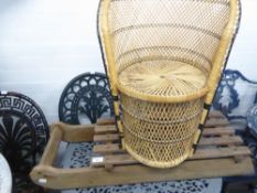 AN OLD WOODEN SLEDGE AND A WICKER CHILD'S ARMCHAIR (2)