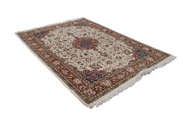 A MODERN PERSIAN WOOL PILE RUG, the cream field with a central medallion surrounded with stylized