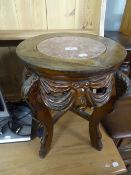 AN ORIENTAL CARVED PADOUK WOOD URN STAND WITH INSET MARBLE TOP