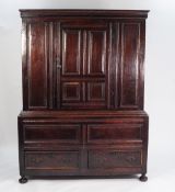 LATE SEVENTEENTH CENTURY PANELLED OAK TWO PART CUPBOARD, the upper section with moulded cornice