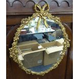 A GILT EDGED OVAL WALL MIRROR