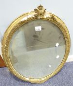 A LATE NINETEENTH/EARLY TWENTIETH CENTURY GILT GESSO OVAL WALL MIRROR, (a.f.) 27" x 21 1/2" overall