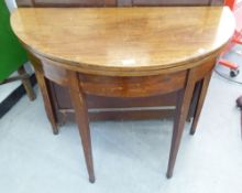 EARLY NINETEENTH CENTURY LINE INLAID MAHOGANY DEMI-LUNE FOLD OVER TEA TABLE, raised on square,