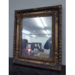 AN EARLY CENTURY GILT GESSO FRAMED WALL MIRROR, 54cm wide x 63cm high