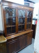 A REPRODUCTION BOOKCASE, GLAZED UPPER PORTION WITH DRAWERS AND CUPBOARDS UNDER